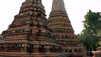 Ancient buddhist temple wat pho featuring ornamental architectural details, highlighting intricate stupa decorations and