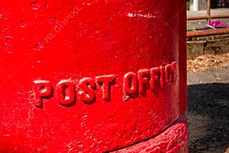 Close-up of a Vibrant Red Royal Mail Post Box with \'POST OFFICE\' Embossed on the Side