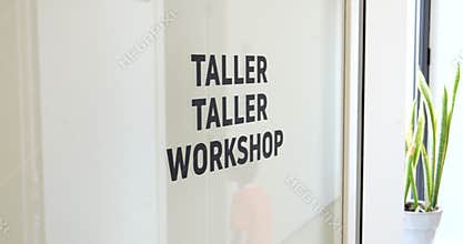 Startup Factory with Bilingual Workshop Sign and Plant