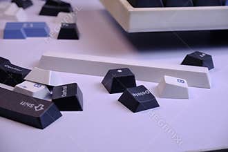 Scattered PBT Doubleshot Keycaps on a Clean White Desk, Coloured White, Blue, and Black
