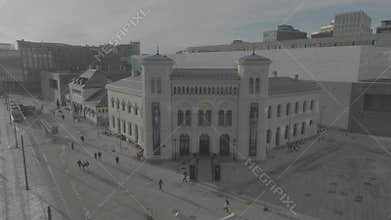 Drone landscape view of the Nobel Peace Center in Oslo, Norway, with people walking by on the street
