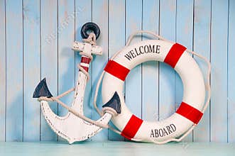 Anchor and life buoy on a background of shabby wall boards