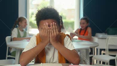 African American little boy sad cry kid schoolboy child pupil suffer learning in school laughing cruel children