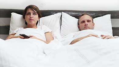 Comic scene - Wife and Husband TV Remote control conflict in Bed