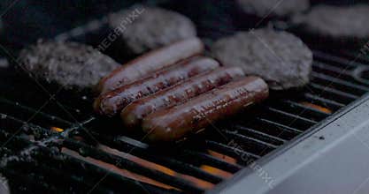 Bbq grill with delicious hamburgers and hot dogs.