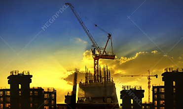 Building and crane construction site against beaut