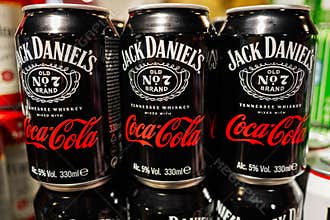 Jack Daniel\'s and Coca-Cola 330ml cans displayed at a beverage store