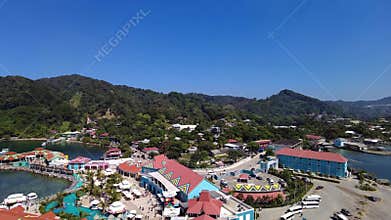 The port area in Roatan, Honduras with colorful buildings, sea and nature