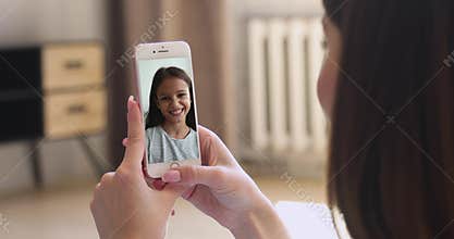 Cute girl talking to mother using videocall app