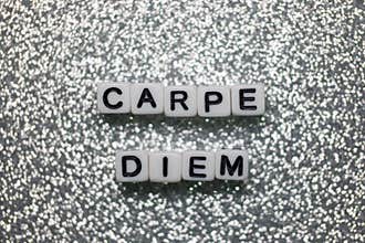 Inspiring message displayed with letter blocks on a shimmering background