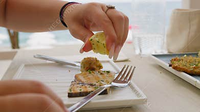 Woman Squeezing Lemon On The Swordfish Food