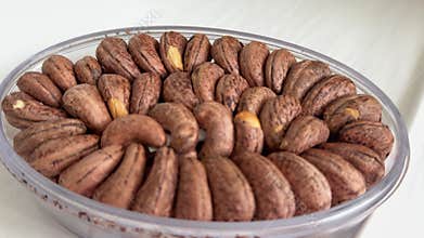 cashew nuts peeled in a plate on white nuts fats useful to peel