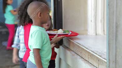 Group Of Elementary Age Children With Teacher In Art Class