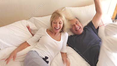 Senior husband and wife jump