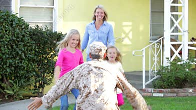 Family Welcoming Husband Home On Army Leave