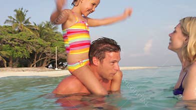 Family Relaxing In Tropical Sea