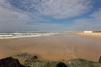 A sand pumping jetty to maintain sand on beaches at a popular tourist destination.