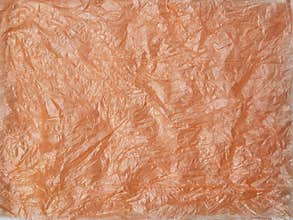Abstrack orange crumpled plastic bag texture background