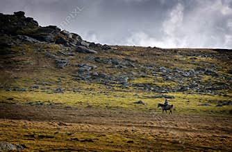 Horse rider on rugged open plains