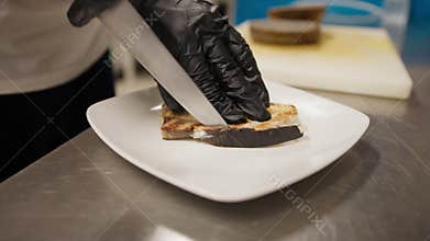 Chef Cleaning The Grilled Swordfish With The Knife During The Dish Preparation