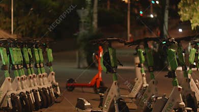 Electric scooters parked at Southbank Parklands, as cars, bikes, and pedestrians move steadily