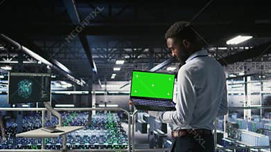 Data center programmers on industrial platform using green screen laptop