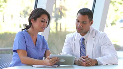 Medical Staff Review Information On Digital Tablet