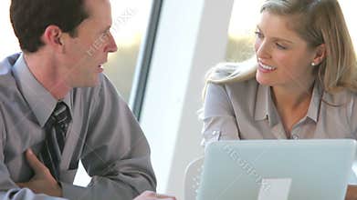 Two Business People With Laptop Having Meeting