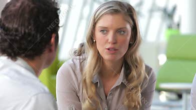 Businessman And Businesswomen Talking In Office