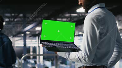 Data center programmers on industrial platform using green screen laptop
