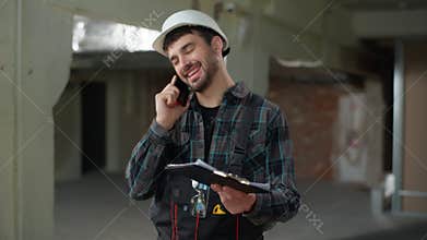 Man builder engineer talking mobile phone building industry smiling foreman male Caucasian guy handyman industrial