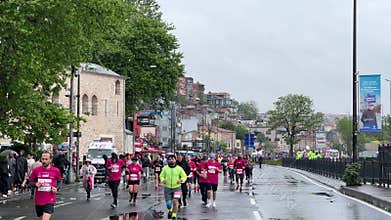 Athletes running Istanbul half marathon in historic street of Fener district