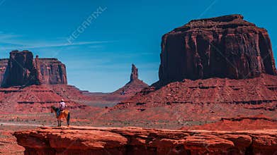 A cowboy on a horse in Monument Valley's Overlook