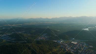 Panoramic Drone View of a Mid-Sized Brazilian City with Buildings and Green Areas Under a Clear Sky