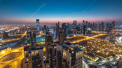 Aerial view of a big modern city day to night timelapse. Business bay, Dubai, United Arab Emirates.