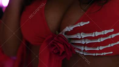 Halloween woman breasts on dress skeleton hand supporting bust close up on ship party in full swing