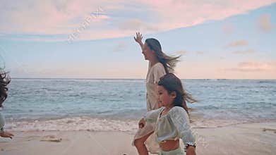 Happy Family of Woman with Young Children Playing at Sea Water of Ocean Beach