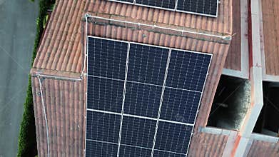 Solar energy with cell panels or PV modules installed on top of house rooftop.