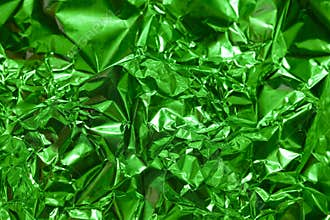 Bright green metallic foil texture creates an abstract and vibrant background for various creative projects
