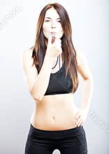 Young fit fitness trainer woman blowing whistle