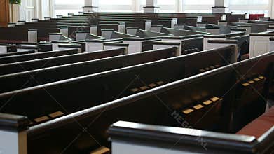 Slow tracking (dolly) shot along church pews