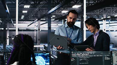 Data center manager supervising work done by programmers on neural network