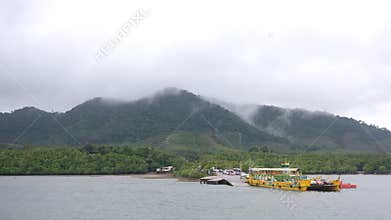 Scenic Tropical Ferry Dock with Misty Mountains