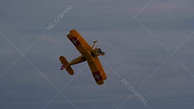 Bucker Bu 133 Jungmeister RC model performing a full roll maneuver