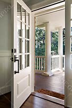 Vertical shot of an open, wooden front door
