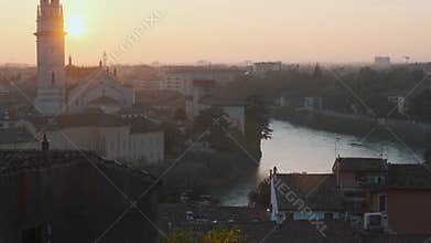 View of Verona old town with bell tower of Verona Cathedral, Adige river, medieval architecture at sunset, Veneto, Italy
