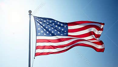 United states flag waving against blue sky
