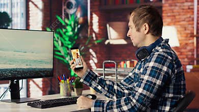 Man in home office looking at social media feed with live broadcasts