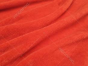Abstrack red silk satin texture background. Beautiful wavy soft folds on the surface of the fabric.