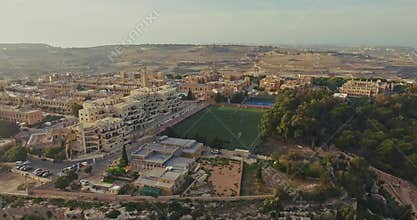 Football stadium in the urban landscape of a city in Malta aerial view.